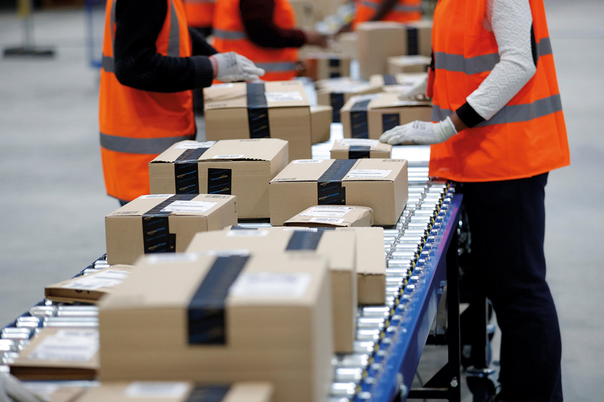 Employees work at the Amazon distribution center in Saran, near Orleans